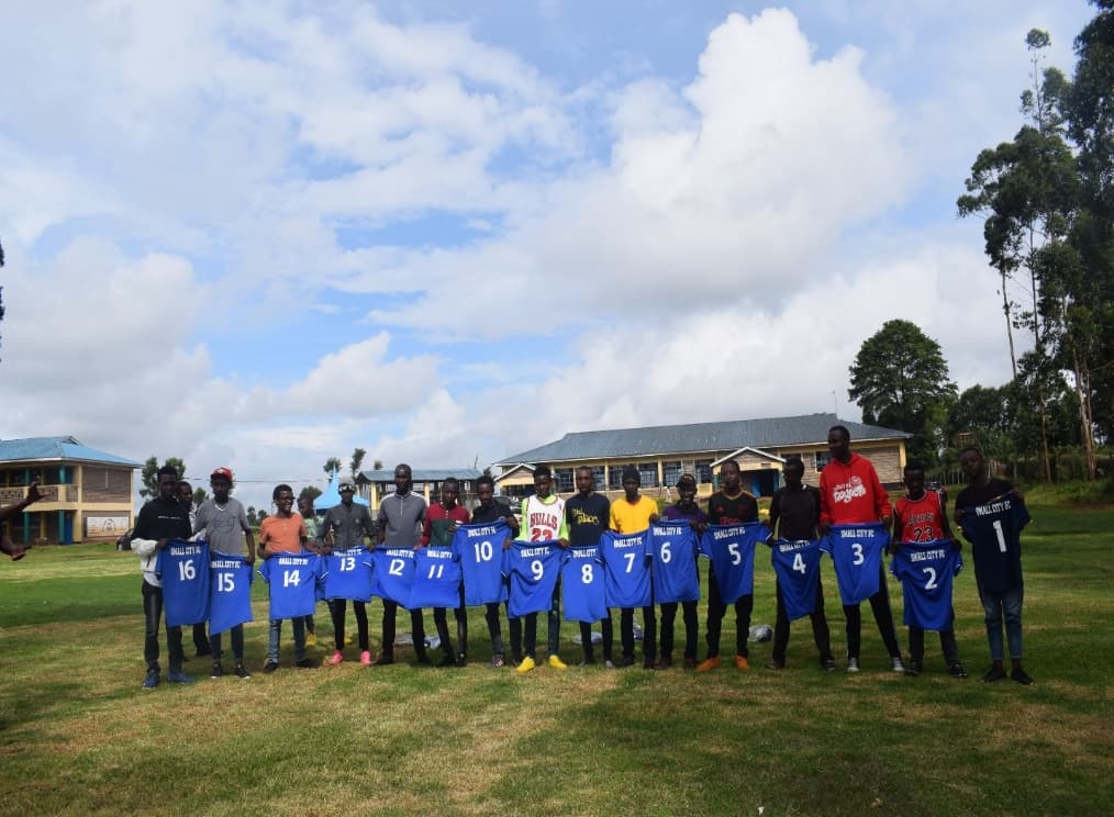 Small City FC awarded full kit by RAA SACCO after student symposium at Gitare High School.